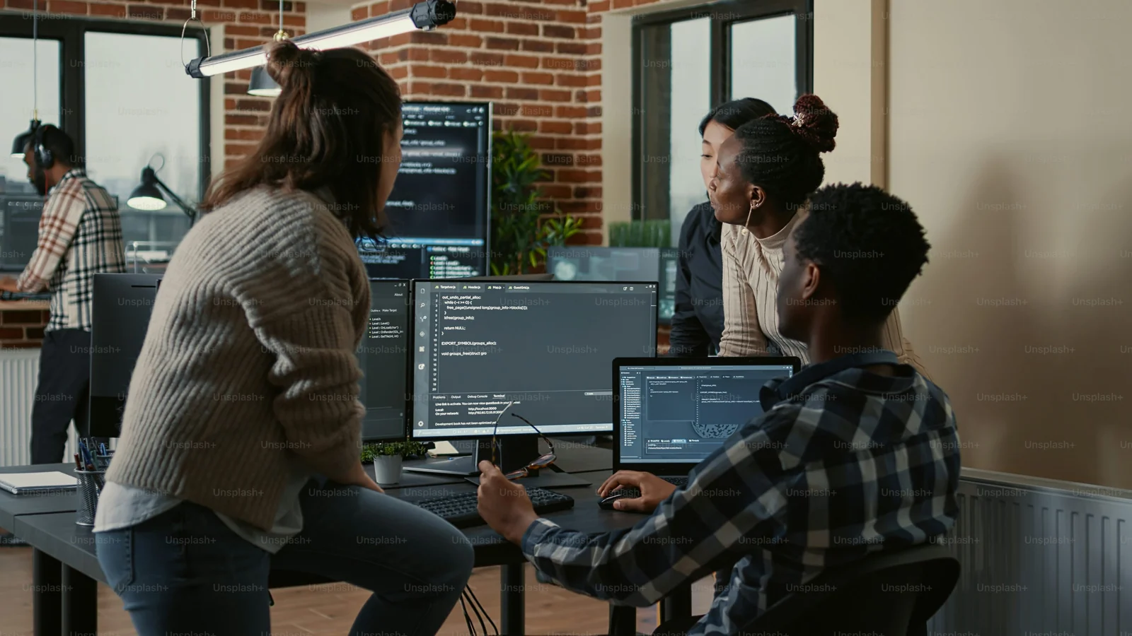 Product team collaborating around screens in an office