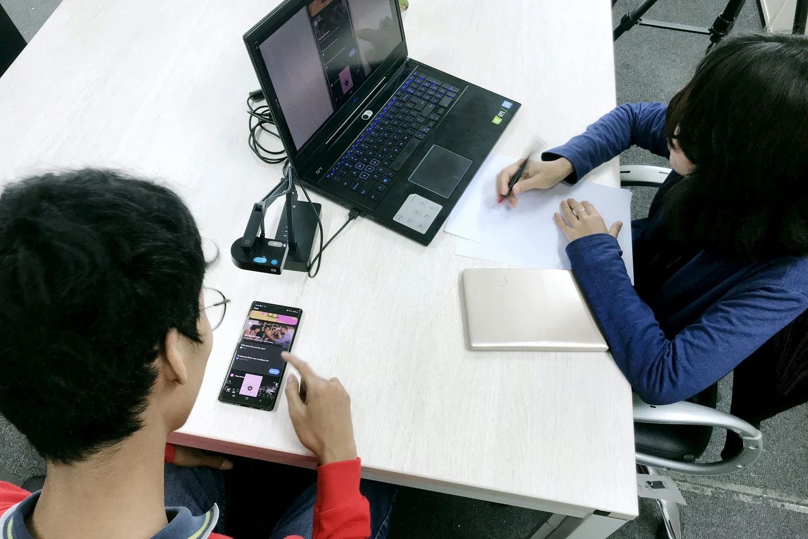 Researcher speaking on a phone in a work setting